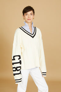 oversized v neck sweater, exaggerated long sleeve, cream cable knit, cream color with black accents, high-low hem length